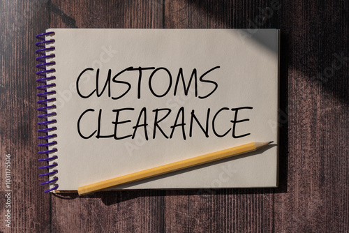 CUSTOMS CLEARANCE text on a sticky on chart with pencil. photo