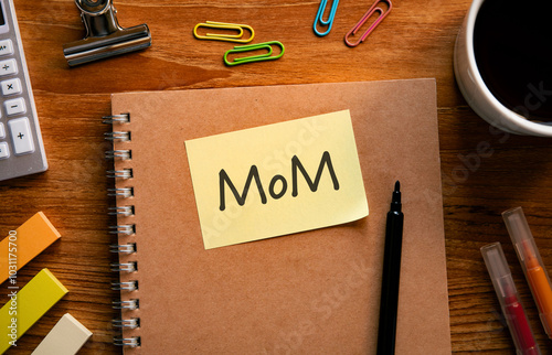 There is sticky note with the word MoM. It is an abbreviation for month over month as eye-catching image. photo