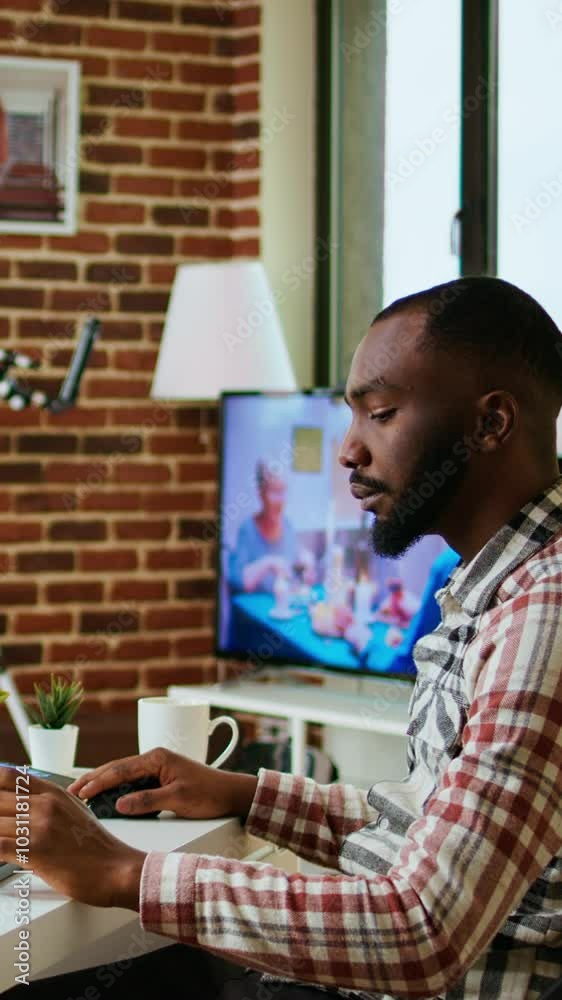 Vertical Video African american software engineer works on a laptop typing code for a development project. Technical specialist multitasking, debugging and using advanced digital tools for coding Vertical Video African american software engineer works on a laptop typing code for a development project. Technical specialist multitasking, debugging and using advanced digital tools for coding