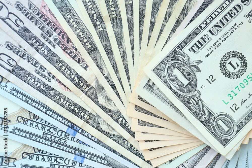 Many dollar bills with different nominations lies in big pile Many dollar bills with different nominations lies in big pile