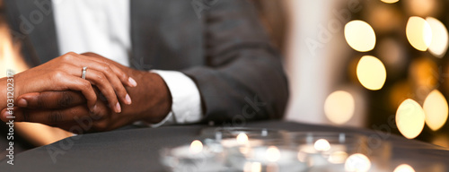 Fotografie Cropped of black man holding woman hand with ring on, got engaged