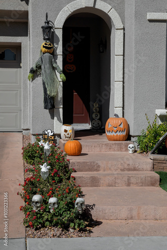 Halloween outdoor decorations with pupmkins, ghosts and skeleton heads photo