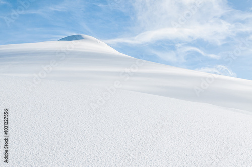 Majestic snow covered mountain peak against clear blue sky, copy space for text or design - Winter natural landscape. Snowdrift sunny day