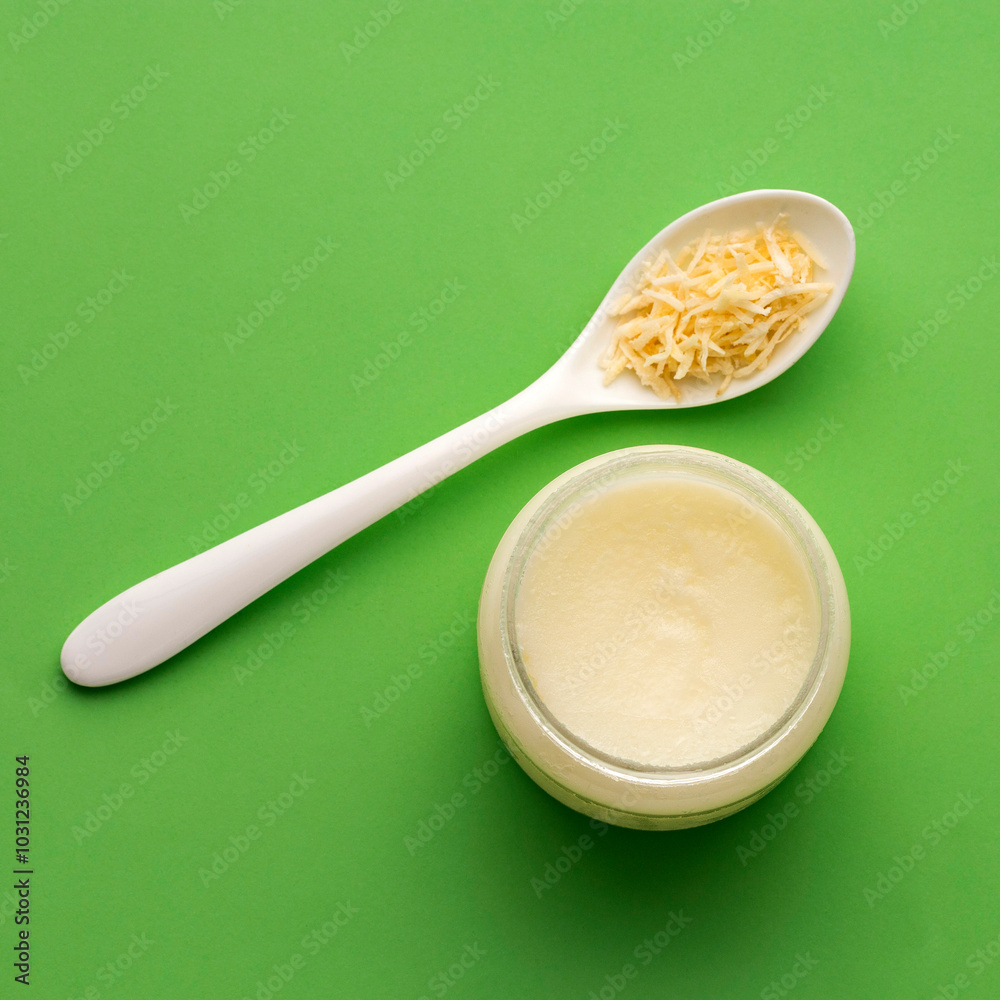 Grated Cocos nucifera in the spoon - Virgin coconut oil. Grated Cocos nucifera in the spoon - Virgin coconut oil.