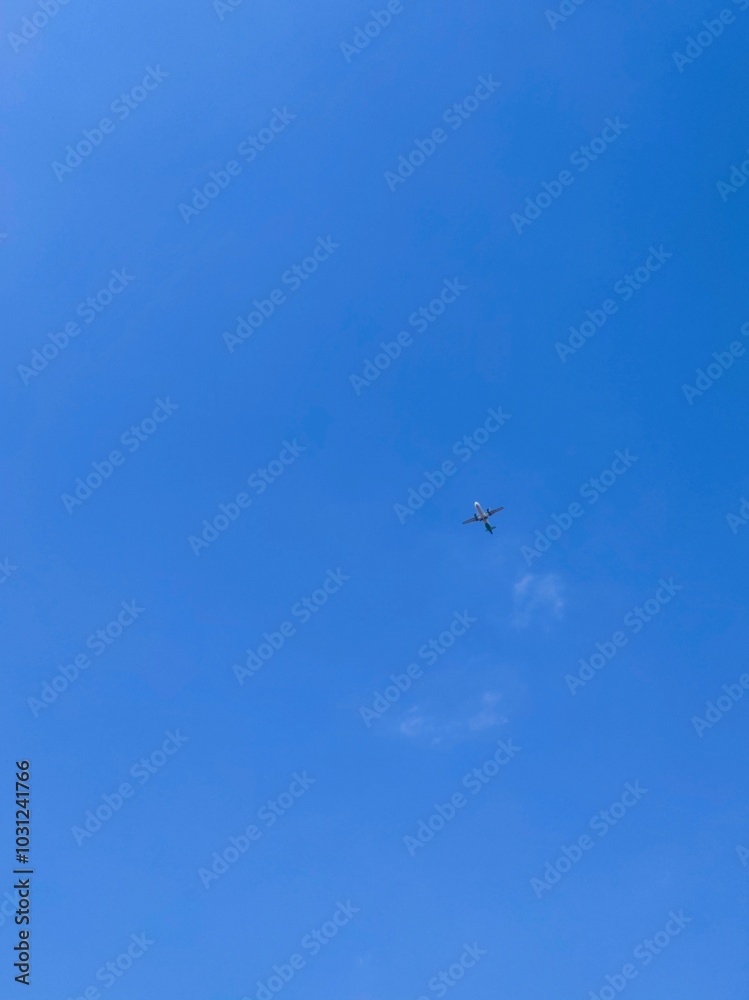 An airplane flying high above the blue sky An airplane flying high above the blue sky