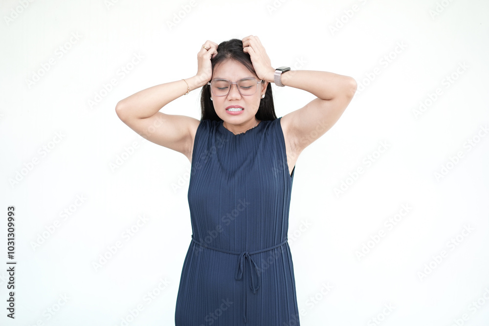 Beautiful Asian woman is shown suffering from a headache, with a pained expression on her face