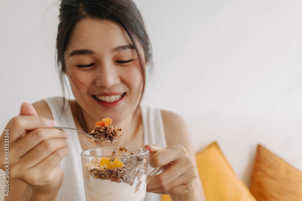 Enjoy face of Asian woman eating dessert made of yogurt. Happy healthy diet. Enjoy face of Asian woman eating dessert made of yogurt. Happy healthy diet.