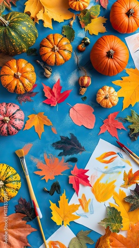 Thanksgiving Kids Art Table with Pumpkins Gourds and Leaves Flatlay with Blue Background