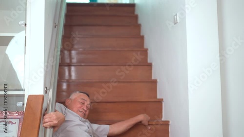 Asian elderly man have an accident while going down the stair.