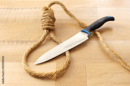 Flat Lay of Rope Noose With Knife on Wooden Background