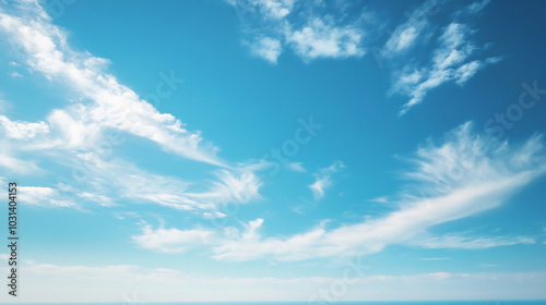 Fototapeta Naklejka Na Ścianę i Meble -  Clear blue sky with soft, wispy clouds drifting across, evoking a sense of peace, freedom, and open possibilities