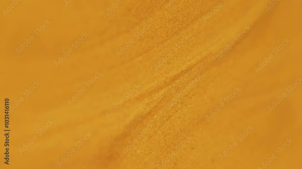 Shimmer fluid spill. Glitter paint texture. Blur orange golden color metallic shiny sand particles acrylic liquid pigment ink flow motion abstract art background.