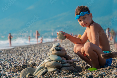  Boy builds a pyramid of stones