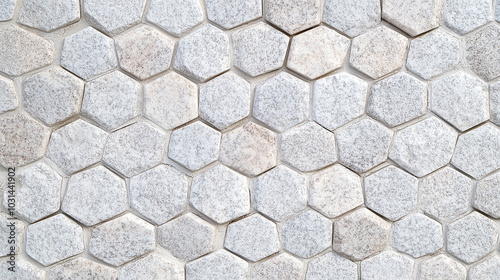 a wall covered in white hexagonal stone tiles. 