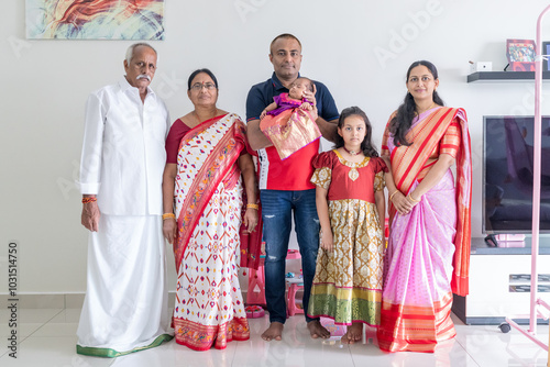 Photography ndian family spending time together, wearing traditional and casual outfits with a baby, a young girl, and grandparents in a high-rise apartment in Kuala Lumpur, Malaysia