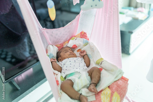 ndian family spending time together, wearing traditional and casual outfits with a baby, a young girl, and grandparents in a high-rise apartment in Kuala Lumpur, Malaysia. photo