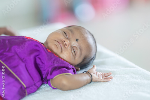 ndian family spending time together, wearing traditional and casual outfits with a baby, a young girl, and grandparents in a high-rise apartment in Kuala Lumpur, Malaysia. photo