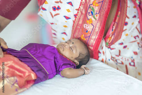 ndian family spending time together, wearing traditional and casual outfits with a baby, a young girl, and grandparents in a high-rise apartment in Kuala Lumpur, Malaysia. photo