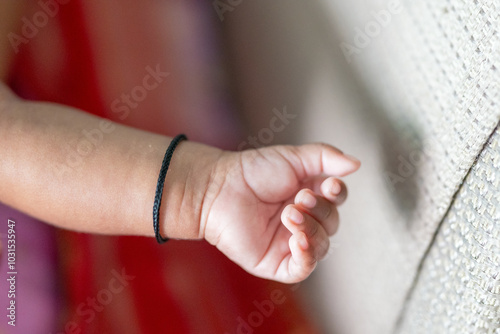 ndian family spending time together, wearing traditional and casual outfits with a baby, a young girl, and grandparents in a high-rise apartment in Kuala Lumpur, Malaysia. photo