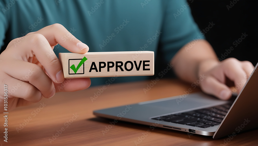 Approved. Businessman holding wooden block with text approve for document approval, assessment, approve the loan, finance agreement, loan, stamp, business. Certified Approved. Businessman holding wooden block with text approve for document approval, assessment, approve the loan, finance agreement, loan, stamp, business. Certified