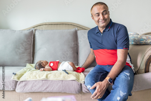 Canvas Print ndian family spending time together, wearing traditional and casual outfits with a baby, a young girl, and grandparents in a high-rise apartment in Kuala Lumpur, Malaysia