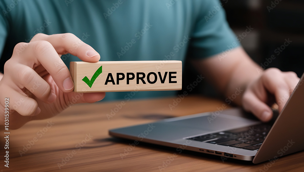 Approved. Businessman holding wooden block with text approve for document approval, assessment, approve the loan, finance agreement, loan, stamp, business. Certified Approved. Businessman holding wooden block with text approve for document approval, assessment, approve the loan, finance agreement, loan, stamp, business. Certified