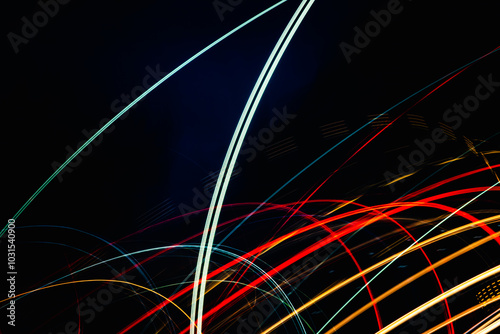 A series of colorful lines and shapes that appear to be moving in a wavy pattern. The image has a dynamic and energetic feel to it