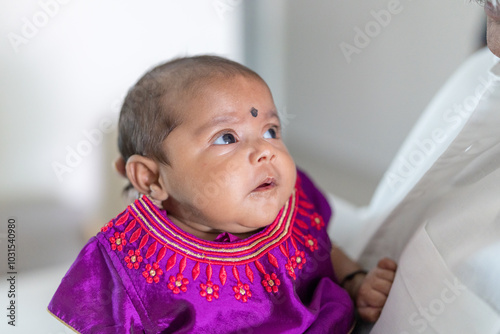Photography ndian family spending time together, wearing traditional and casual outfits with a baby, a young girl, and grandparents in a high-rise apartment in Kuala Lumpur, Malaysia