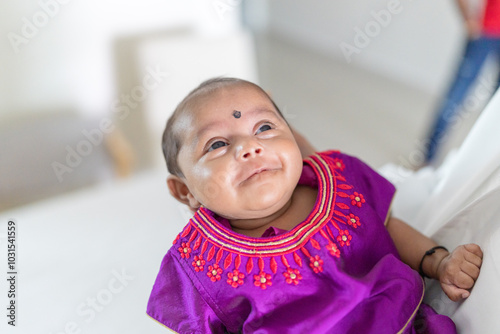 Photography ndian family spending time together, wearing traditional and casual outfits with a baby, a young girl, and grandparents in a high-rise apartment in Kuala Lumpur, Malaysia
