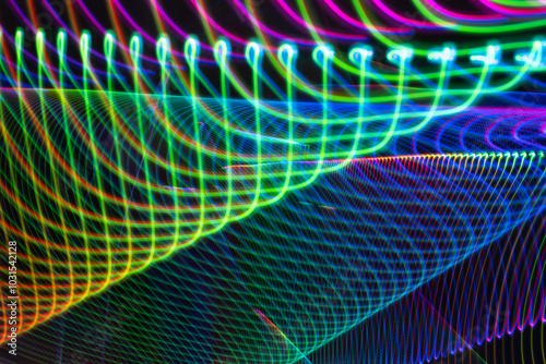 A colorful, abstract image with a rainbow of colors and a lot of lines. The image is full of energy and movement, and it seems to be a representation of a futuristic, otherworldly environment