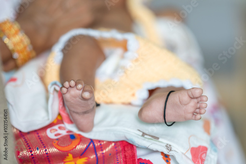 ndian family spending time together, wearing traditional and casual outfits with a baby, a young girl, and grandparents in a high-rise apartment in Kuala Lumpur, Malaysia. photo