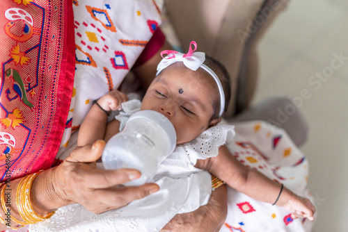 Photography ndian family spending time together, wearing traditional and casual outfits with a baby, a young girl, and grandparents in a high-rise apartment in Kuala Lumpur, Malaysia