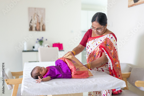 Photography ndian family spending time together, wearing traditional and casual outfits with a baby, a young girl, and grandparents in a high-rise apartment in Kuala Lumpur, Malaysia