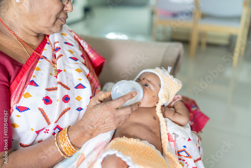 Photography ndian family spending time together, wearing traditional and casual outfits with a baby, a young girl, and grandparents in a high-rise apartment in Kuala Lumpur, Malaysia