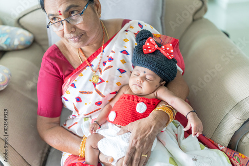 Canvas Print ndian family spending time together, wearing traditional and casual outfits with a baby, a young girl, and grandparents in a high-rise apartment in Kuala Lumpur, Malaysia