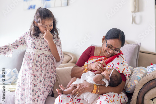 Photography ndian family spending time together, wearing traditional and casual outfits with a baby, a young girl, and grandparents in a high-rise apartment in Kuala Lumpur, Malaysia