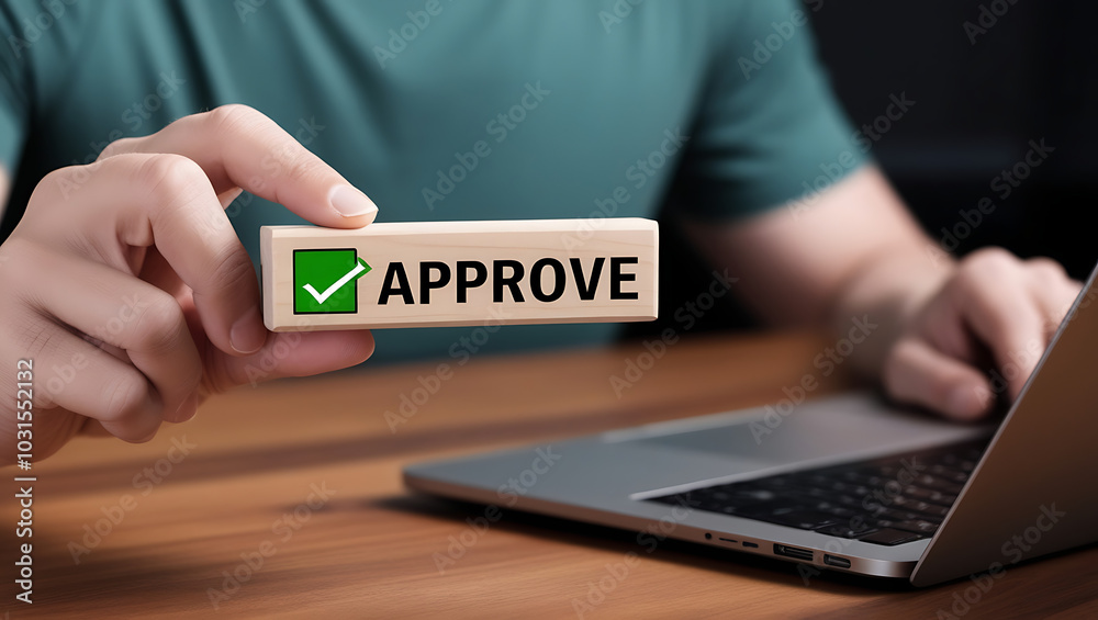 Approved. Businessman holding wooden block with text approve for document approval, assessment, approve the loan, finance agreement, loan, stamp, business. Certified Approved. Businessman holding wooden block with text approve for document approval, assessment, approve the loan, finance agreement, loan, stamp, business. Certified
