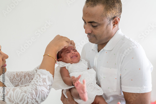 Photography ndian family spending time together, wearing traditional and casual outfits with a baby, a young girl, and grandparents in a high-rise apartment in Kuala Lumpur, Malaysia