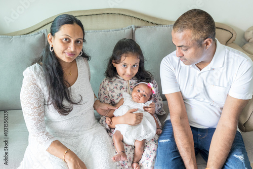 Photography ndian family spending time together, wearing traditional and casual outfits with a baby, a young girl, and grandparents in a high-rise apartment in Kuala Lumpur, Malaysia