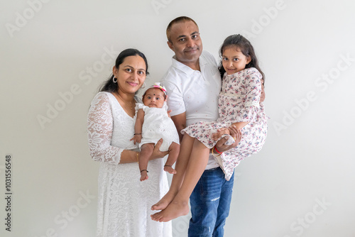 Photography ndian family spending time together, wearing traditional and casual outfits with a baby, a young girl, and grandparents in a high-rise apartment in Kuala Lumpur, Malaysia