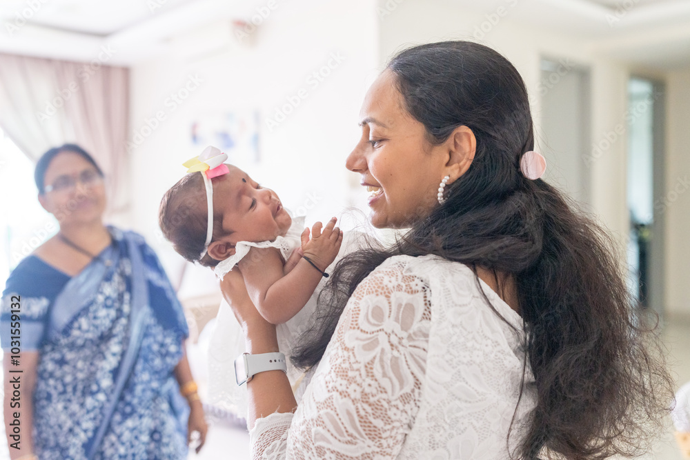 ndian family spending time together, wearing traditional and casual outfits with a baby, a young girl, and grandparents in a high-rise apartment in Kuala Lumpur, Malaysia. ndian family spending time together, wearing traditional and casual outfits with a baby, a young girl, and grandparents in a high-rise apartment in Kuala Lumpur, Malaysia.