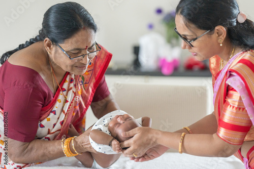Canvas Print ndian family spending time together, wearing traditional and casual outfits with a baby, a young girl, and grandparents in a high-rise apartment in Kuala Lumpur, Malaysia