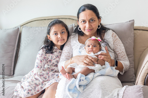 Photography ndian family spending time together, wearing traditional and casual outfits with a baby, a young girl, and grandparents in a high-rise apartment in Kuala Lumpur, Malaysia