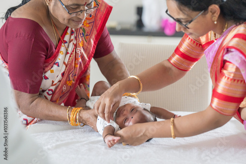 Photography ndian family spending time together, wearing traditional and casual outfits with a baby, a young girl, and grandparents in a high-rise apartment in Kuala Lumpur, Malaysia