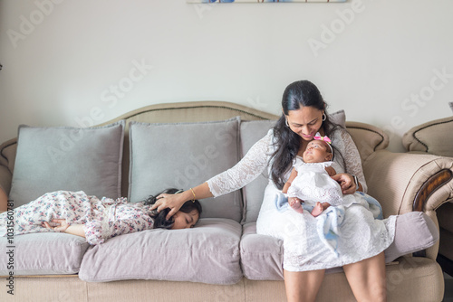 Canvas Print ndian family spending time together, wearing traditional and casual outfits with a baby, a young girl, and grandparents in a high-rise apartment in Kuala Lumpur, Malaysia