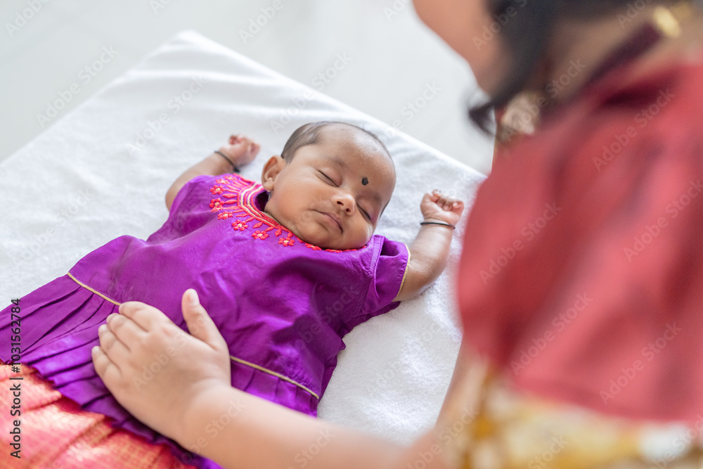 ndian family spending time together, wearing traditional and casual outfits with a baby, a young girl, and grandparents in a high-rise apartment in Kuala Lumpur, Malaysia. ndian family spending time together, wearing traditional and casual outfits with a baby, a young girl, and grandparents in a high-rise apartment in Kuala Lumpur, Malaysia.