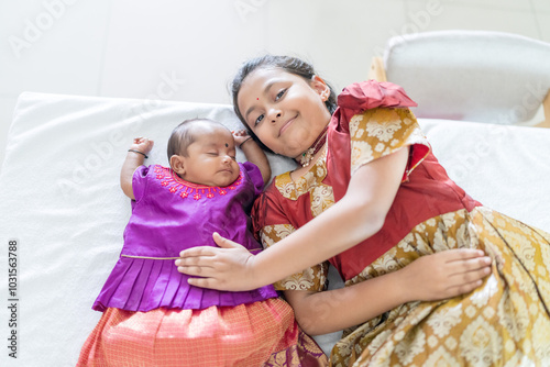 ndian family spending time together, wearing traditional and casual outfits with a baby, a young girl, and grandparents in a high-rise apartment in Kuala Lumpur, Malaysia. photo