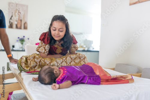 Photography ndian family spending time together, wearing traditional and casual outfits with a baby, a young girl, and grandparents in a high-rise apartment in Kuala Lumpur, Malaysia