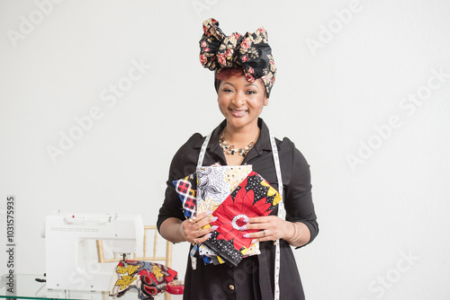 Woman holding her fabric in front of her sowing machine photo