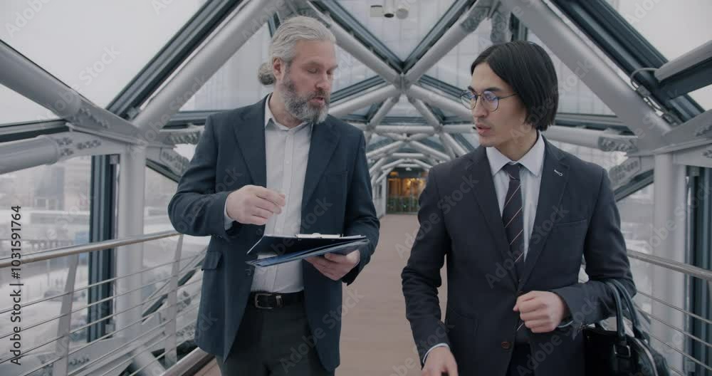 custom made wallpaper toronto digitalDolly shot of two businessmen walking in modern glass corridor talking discussing documents in futuristic office building. Professional communication and businesspeople concept.
